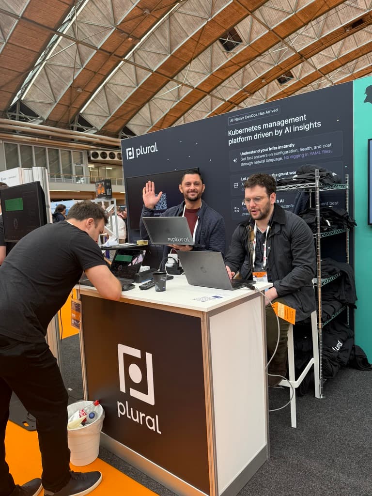 Teammates working the Plural conference booth